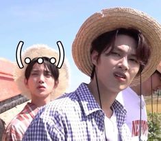 two young men wearing straw hats standing next to each other