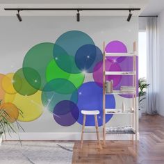 an abstract wall mural in a living room with wooden flooring and white walls, featuring colorful