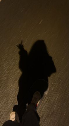 the shadow of a person riding a skateboard