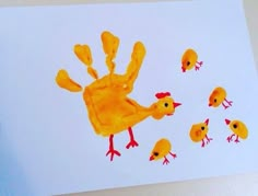 a child's handprint with yellow chickens on it