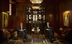 two men in suits sitting next to each other