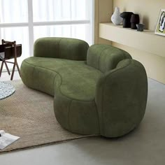 a living room scene with focus on the green couch and chair in the foreground