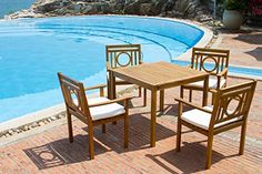 an outdoor table and chairs next to a swimming pool