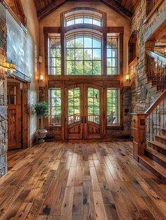 the inside of a large house with wood floors and stonework on the front door