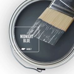 a paint can with a brush in it and the words midnight blue on top of it