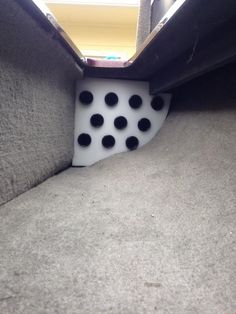 a pair of dices sitting on top of a carpeted floor next to a window