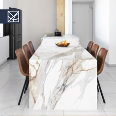 a marble dining table with brown chairs and a bowl of fruit on it's end