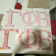 the letters are cut out from paper and placed on top of a table with other crafting supplies