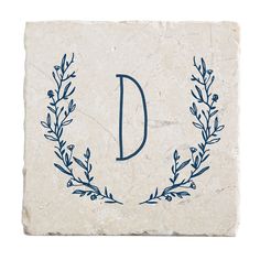 a stone coaster with the letter d on it