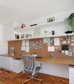 an office with a desk, chair and bookshelf on the wall above it