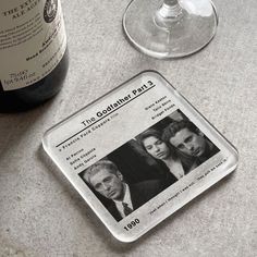 a wine glass next to a bottle of wine and a label on the counter top