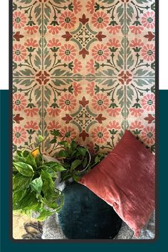 a potted plant sitting next to a decorative wallpaper