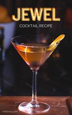 a cocktail in a martini glass with an orange peel garnish