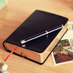 a book with a pen on top of it