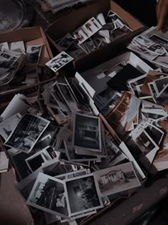 an open box filled with old black and white photos