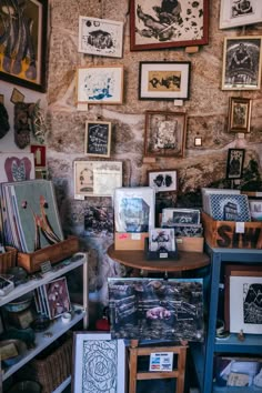 a room filled with lots of framed pictures and art