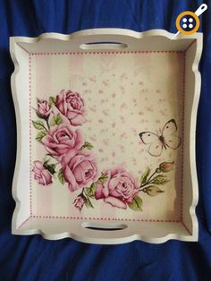 a white tray with pink roses and a butterfly on it