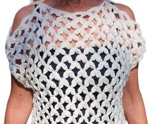 a woman wearing a white crochet top