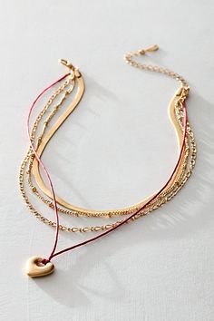 Get an effortless, layered look with this multi-strand necklace, featuring assorted chains and hanging heart pendant. **Features:** Layered style, mixed chain design, corded pendant, heart charm, adjustable clasp closure **Why We | Sloane Layered Necklace by Free People in Gold Chic Multi-strand Layered Necklace With Delicate Chain, Chic Layered Multi-strand Necklace With Double Chain, Chic Everyday Multi-strand Layered Necklace, Dainty Gold-plated Multi-strand Layered Necklace, Gold-tone Multi-strand Layered Necklace, Layered Style, Pendant Heart, Layer Style, Chain Design