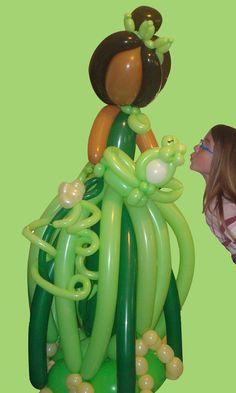 a woman looking at an inflatable balloon sculpture