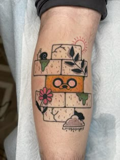 a man with a tattoo on his leg has a piece of cheese in the shape of a face