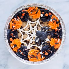 an overhead view of a halloween dessert with sprinkles and spider web decorations