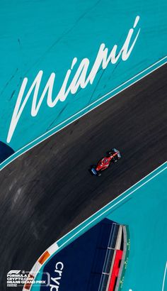 an aerial view of a race car driving on a track with the word miami painted on it