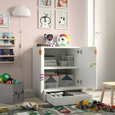 a child's playroom with toys and bookshelves on the floor in front of pink walls