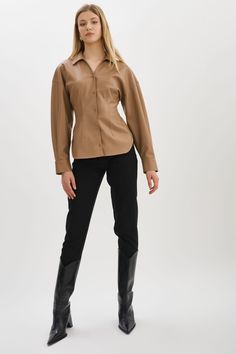 Indulge your fashion sensibilities with the irresistible allure of the Skylar Faux Leather Shirt. Designed to captivate, this statement piece boasts an hourglass silhouette & tapered waist. Modern Fitted Blouse For Business Casual, Sleek Fitted Blouse With Spread Collar, Chic Brown Tops For Business Casual, Chic Brown Top For Business Casual, Sleek Tops For Office Wear In Fall, Sleek Fall Tops For Office Wear, Trendy Fitted Top With Spread Collar, Fitted Leather Button-up Top, Fitted Long Sleeve Leather Top