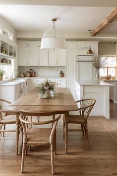 a wooden table sitting in the middle of a kitchen