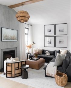 a living room filled with furniture and pictures on the wall