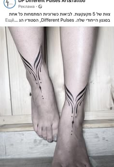 a woman's feet with tattoos on them and the bottom part of her legs