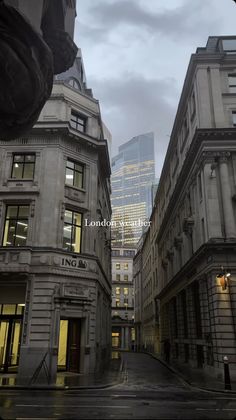 an empty city street with tall buildings in the background