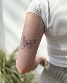 a woman with a small tattoo on her arm