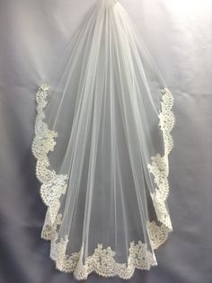 a white veil with lace on it