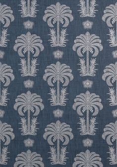 a blue and white fabric with palm trees on it