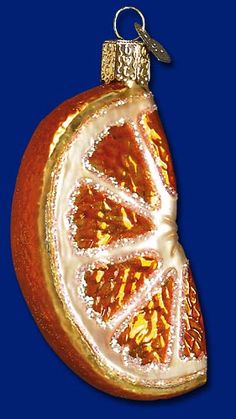 an orange ornament hanging on a blue background