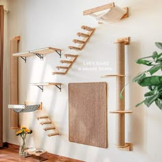 a cat tree and scratching board in the corner of a room with wooden shelves on the wall