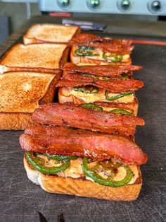 there are many sandwiches on the counter ready to be cooked in the oven for consumption