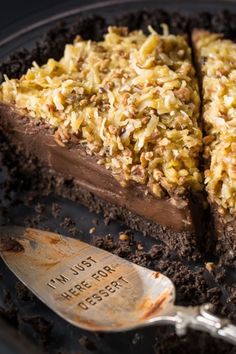 a piece of chocolate cake on a plate with a spoon