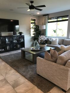 a living room filled with furniture and a flat screen tv