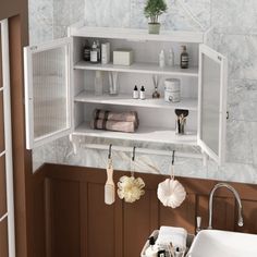 a white sink sitting under a bathroom mirror next to a shelf filled with personal care items