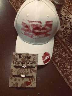 a white hat with blood on it sitting on top of a table