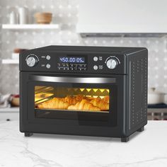 an oven with food cooking in it on a counter top next to shelves and utensils