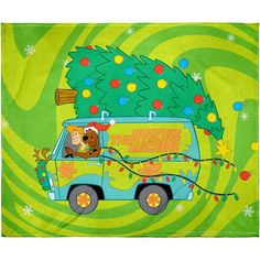 there is a christmas tree on the back of a van with a teddy bear in it