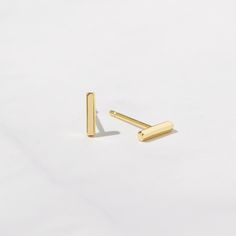 Rectange/Bar Shaped Earrings are great alone or layered. Adds a dainty, and sophisticated touch to your ears and are perfect for any occasion. You can dress them up or down. Product Details: * Sold as a Pair * Made of 925 Sterling Silver * Available in a thick plating of 14k Gold, Rose Gold or Rhodium * Measures 7mm long x 1.5 mm thick * Push Back Closing * Hypoallergenic and nickel - free ♥︎ ♥︎ ♥︎ Model Details ♥︎ ♥︎ ♥︎ 1st Hole- (size 7mm) https://www.etsy.com/listing/1200912558/gold-hoop-earr Earrings Simple Gold, Layering Diamond Necklaces, Line Earrings, Gold Bar Earrings, Small Gold Hoops, Simple Stud Earrings, Bar Studs, Earrings Simple, Earrings Dainty