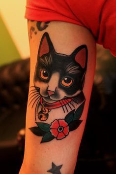 a woman with a cat tattoo on her arm