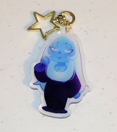 a keychain with an image of a cartoon character and a star on it