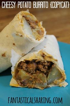 two burritos sitting on top of a blue plate with text overlay that reads cheesy potato burrito copycat?