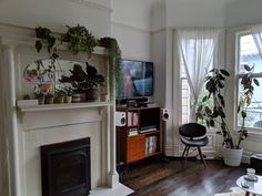 a living room filled with furniture and a flat screen tv mounted to a fire place